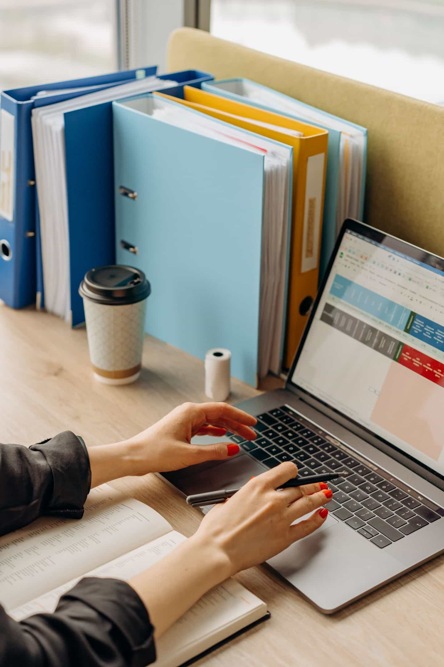Hands typing on a laptop while sharing a recording from a desk